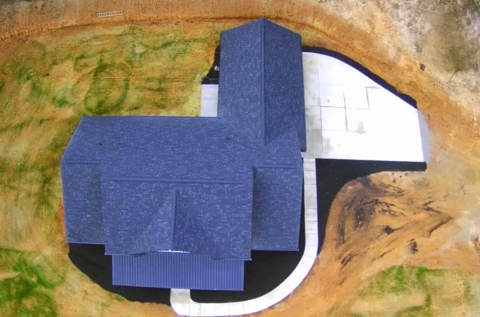 Aerial view of Modern Farmhouse Plan 041-00216 — completed build, Square Built Construction Services