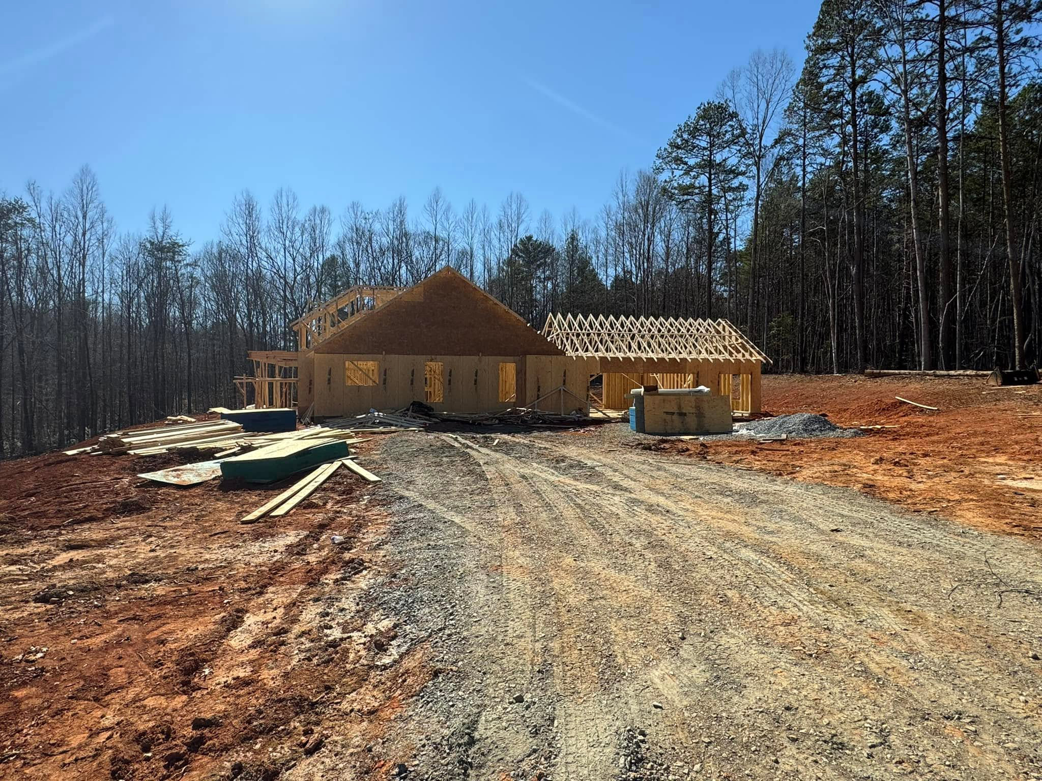 Modern Farmhouse Plan 041-00216 under construction — framing phase, Square Built Construction Services