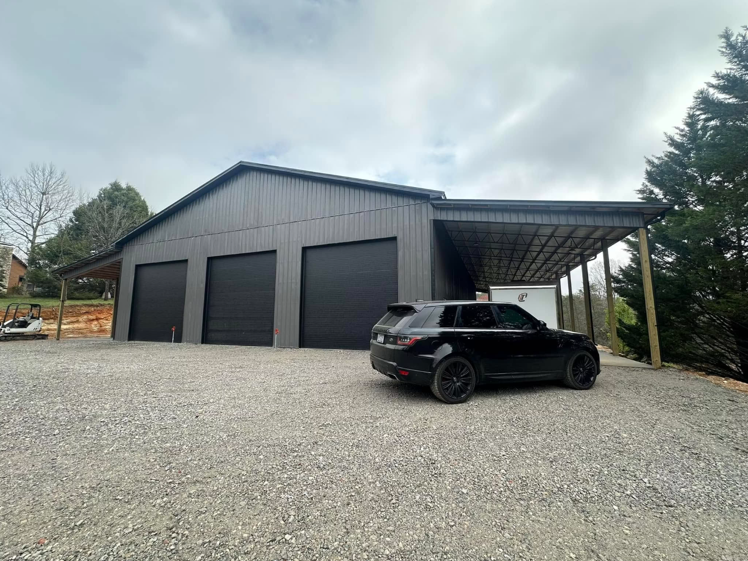 Large three-bay steel garage with attached lean-to